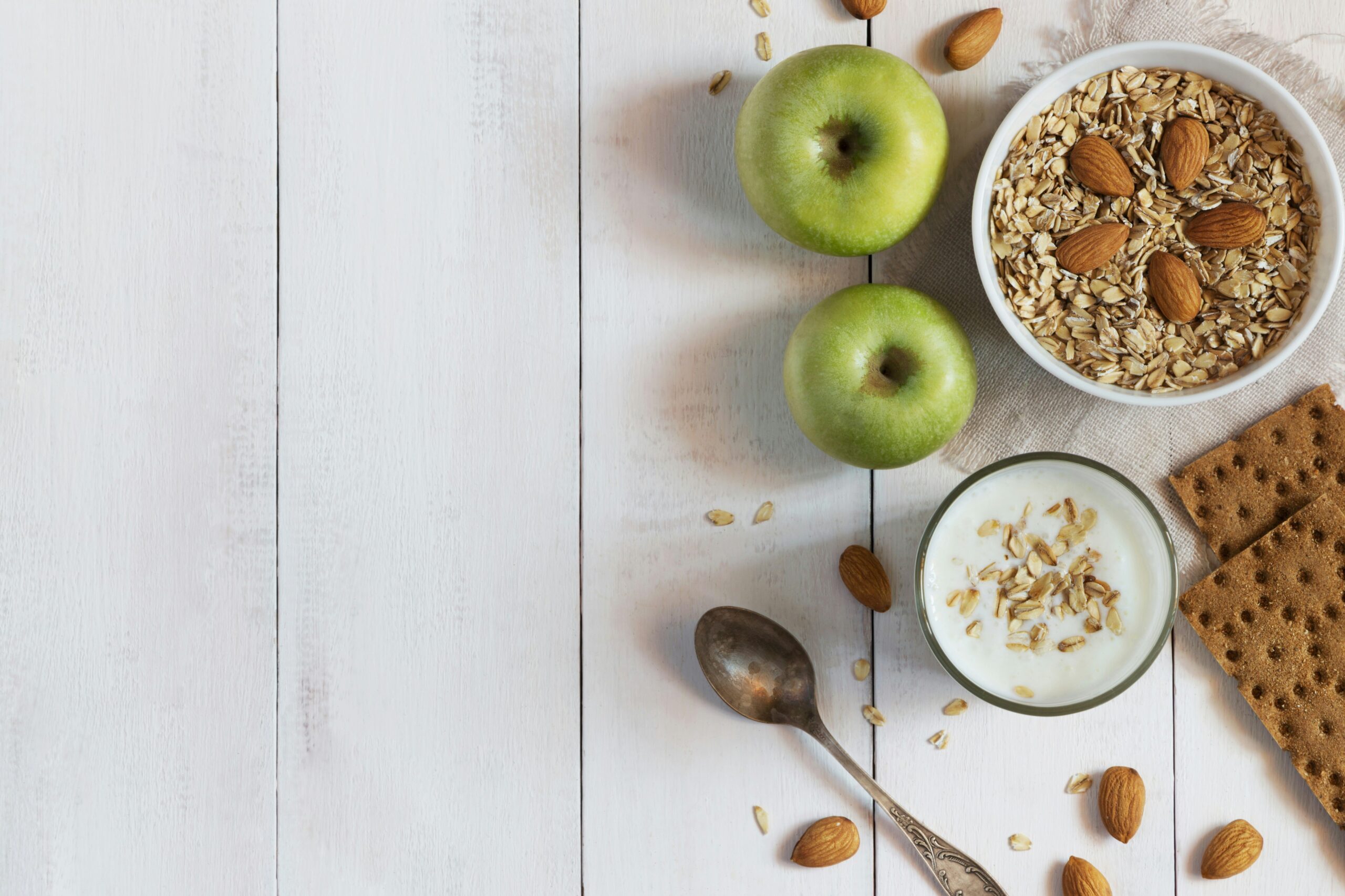 foods that help you sleep better at night - healthy sleep promoting foods laid out on wooden table - Photo by Elena Leya on U